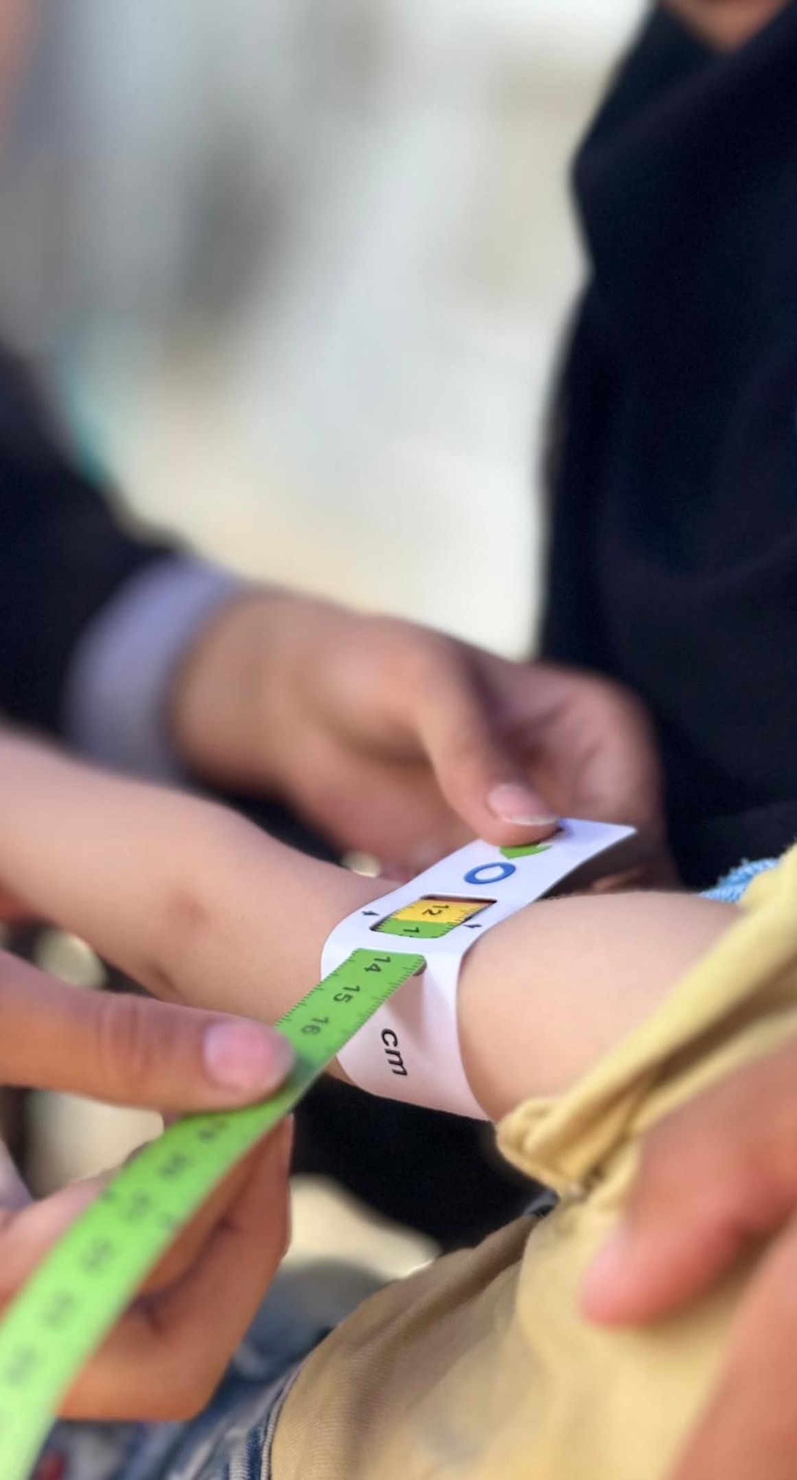 A child's upper arm is measured for malnutrition in Gaza.