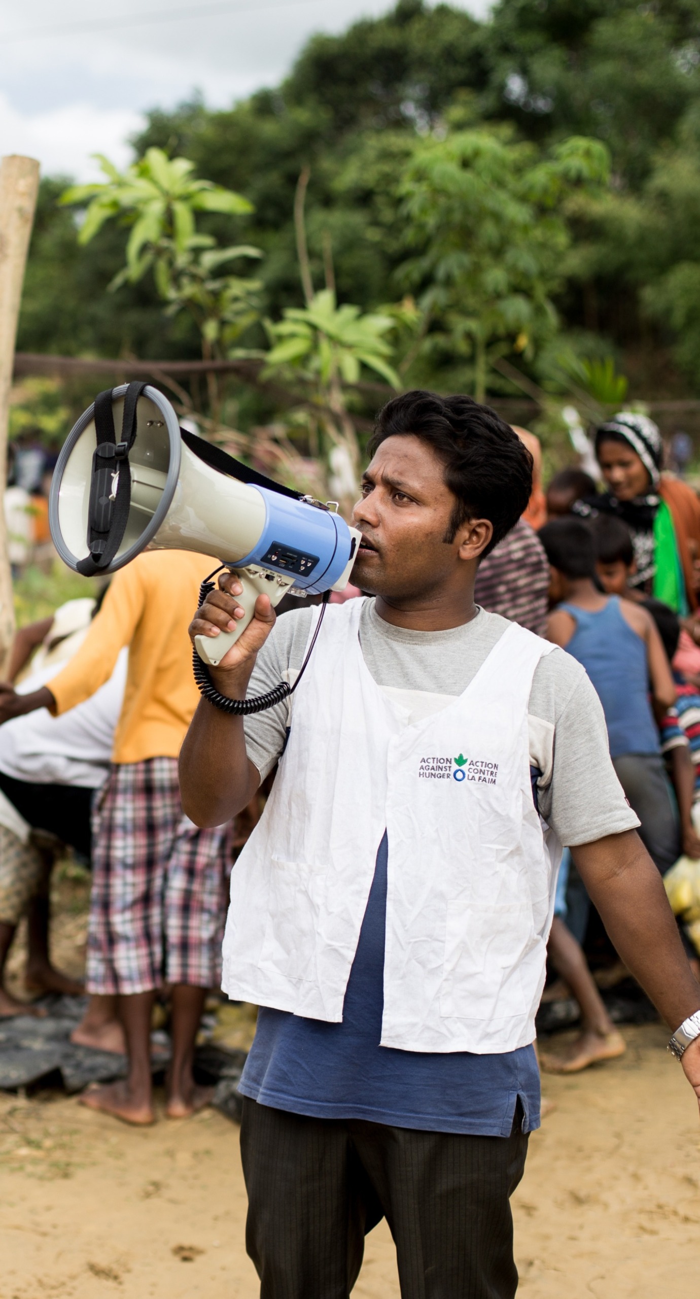 An Action Against Hunger aid worker organizes an emergency food distribution for Rohingya refugees in Cox's Bazar, Bangladesh