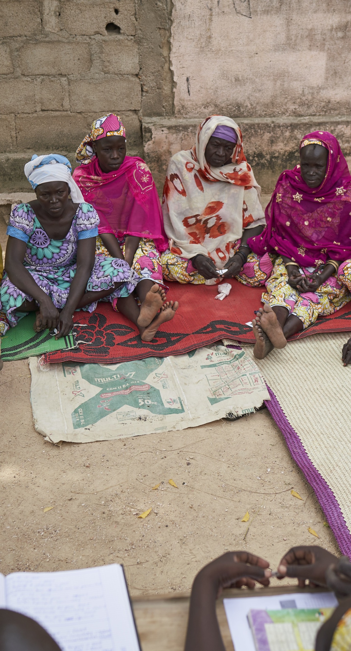 A meeting of a women's savings and loans association, where women learn to pool their resources and save for emergencies and investments.