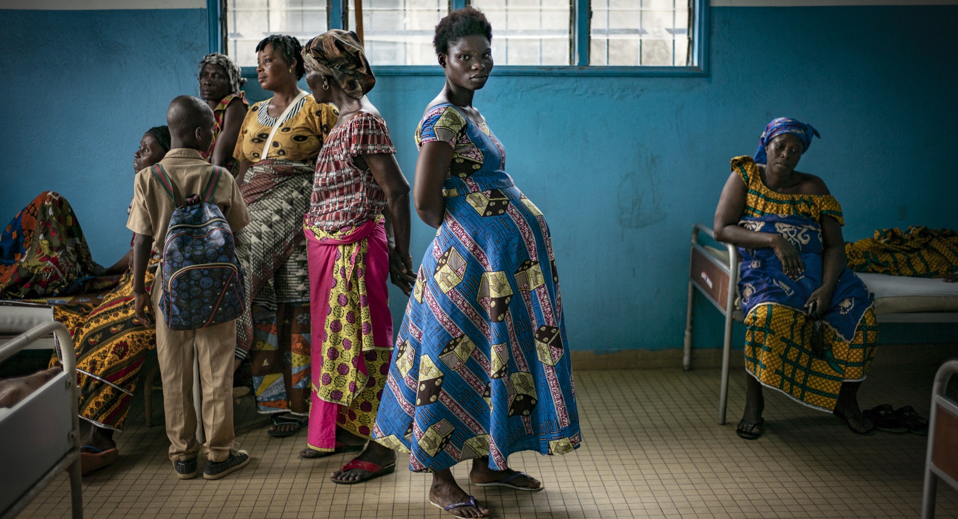 A pregnant woman waits inside a health center in Bacabo, Ivory Coast.