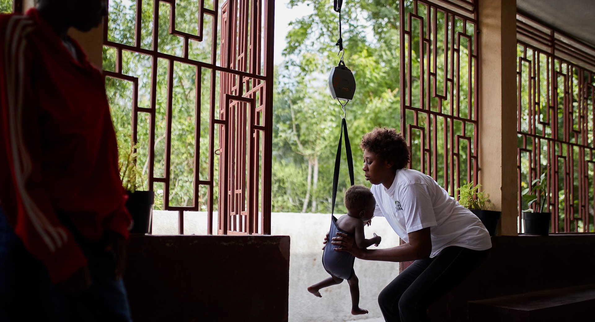 At a health clinic, a child is weighed and screened for malnutrition. Right now, millions of people in Haiti - many of them children - face a serious hunger crisis.