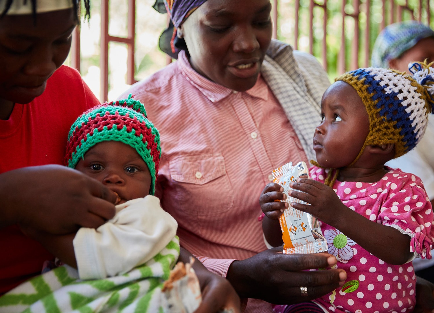 Mothers give their children treatment for malnutrition at an Action Against Hunger supported health center.