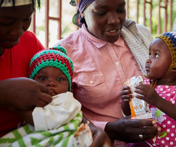 Mothers give their children treatment for malnutrition at an Action Against Hunger supported health center.