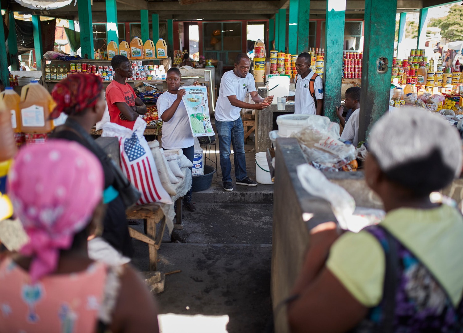 To help prevent the spread of cholera, Action Against Hunger runs a hygiene awareness session at a market in Haiti.