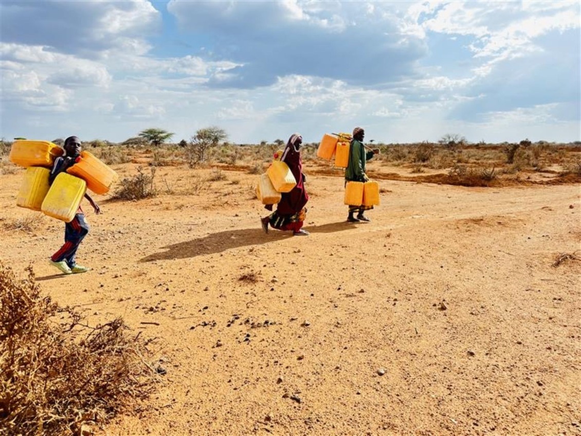 People walk long distances to get water in Somalia