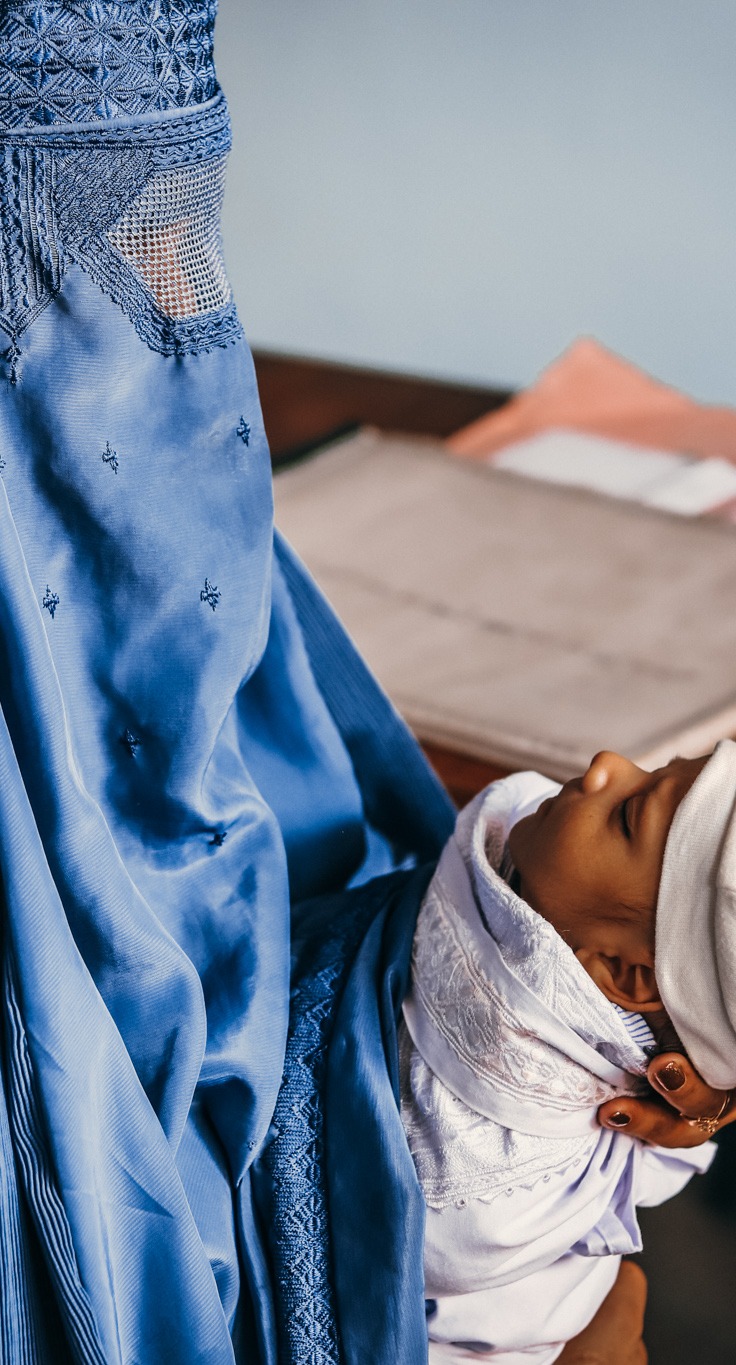 A mother learns about post-natal care during a medical consultation. (Parwan province, October 2020)