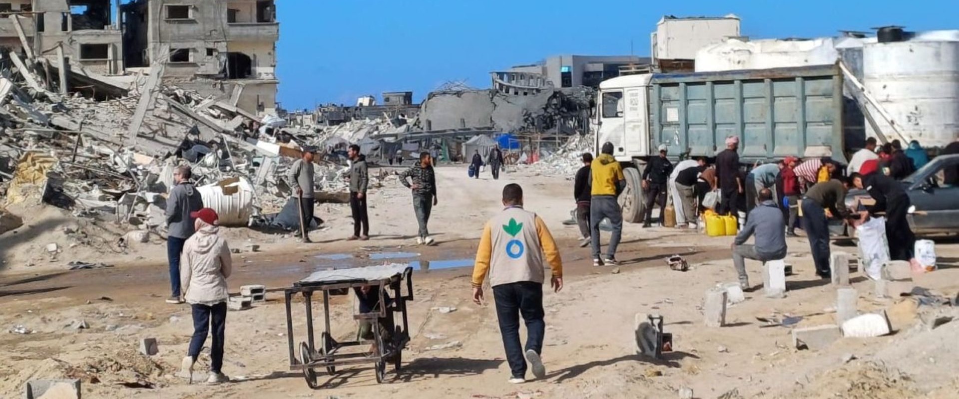 Action Against Hunger aid worker walking amidst rubble in Gaza in January 2025.