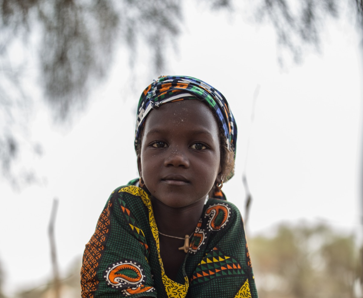 A young girl with a jerrycan.