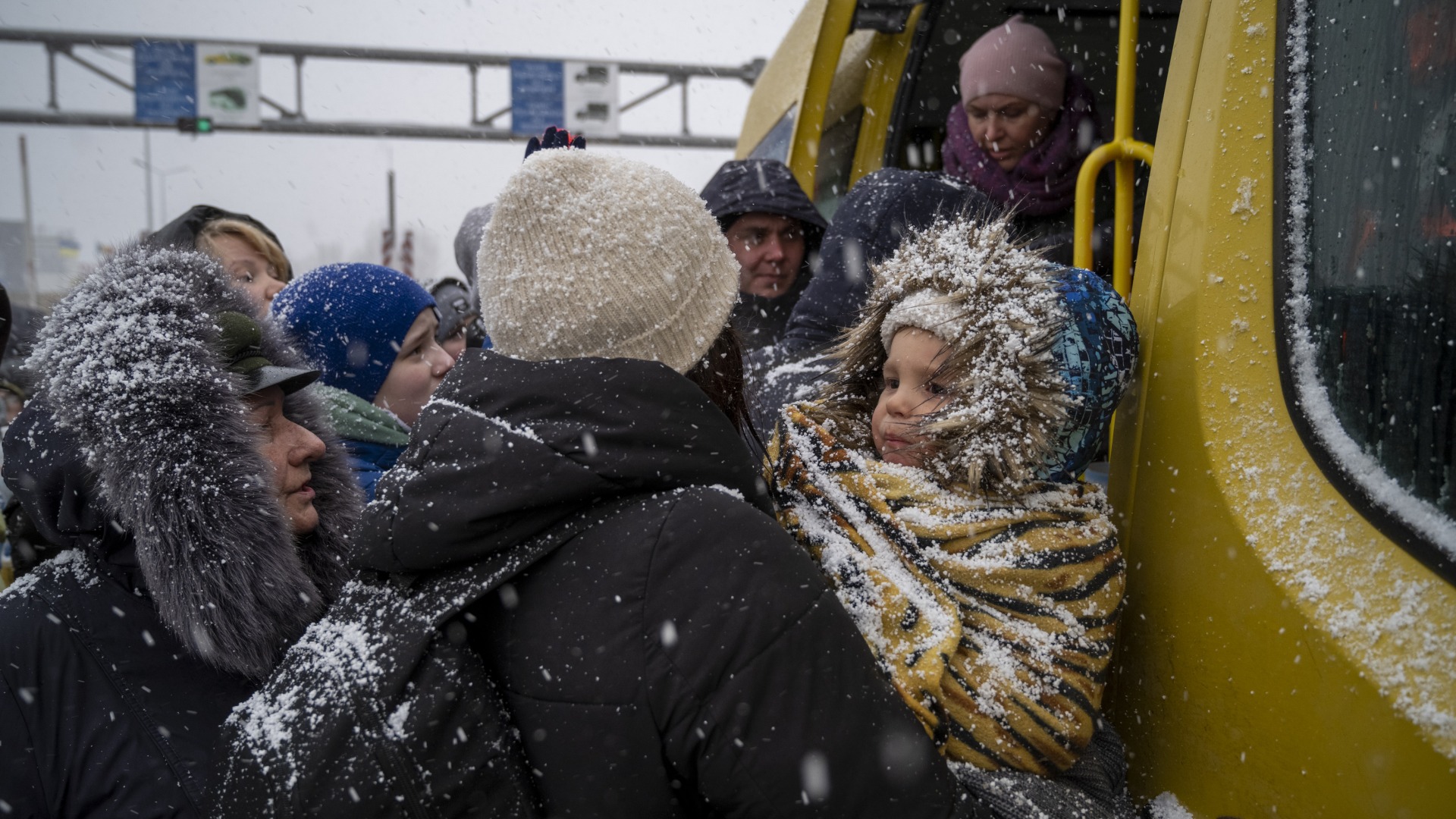Ukrainian refugees face winter weather as they board a bus and cross the border into Moldova.