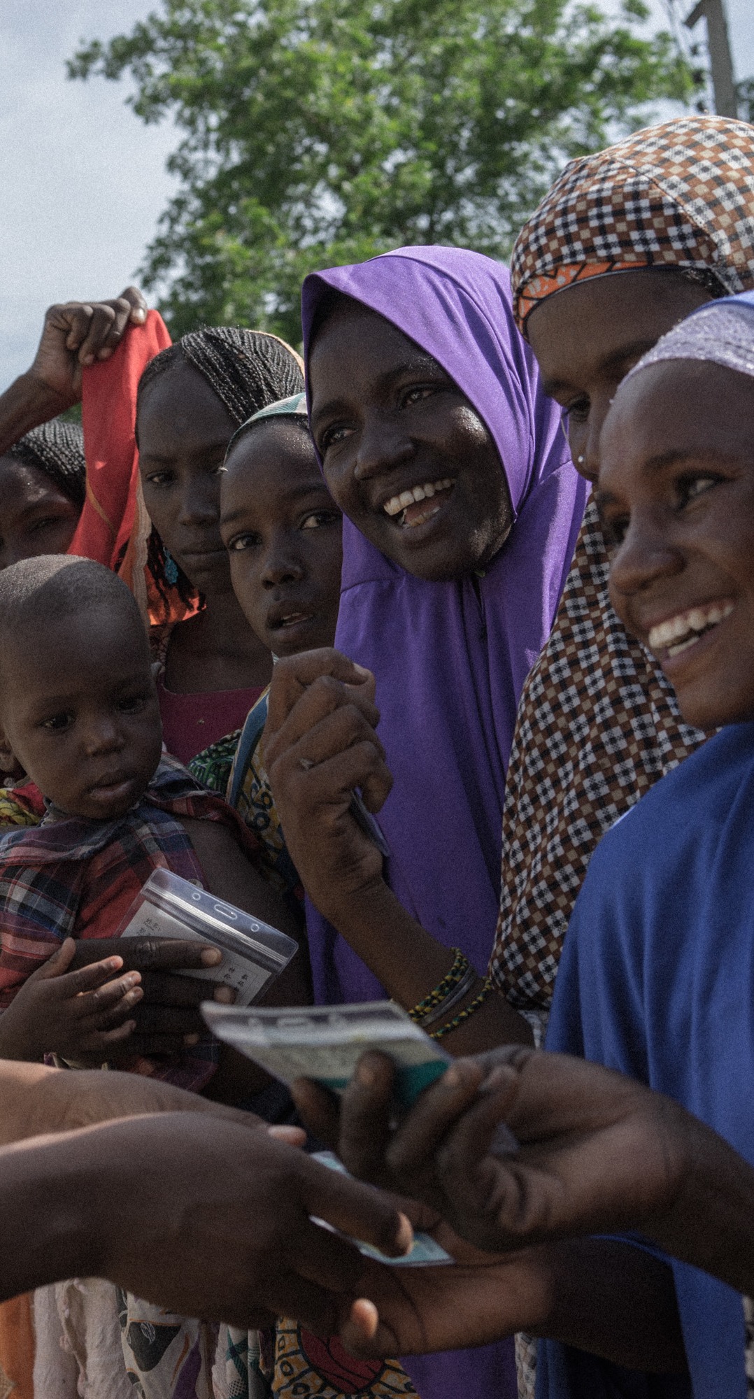 Action Against Hunger staff conduct a distribution of hundreds of shelter kits and hygiene kits to displaced people in Monguno, Borno State, Nigeria