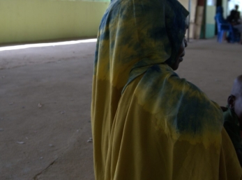 A 27-year-old mother and seasonal farmer receives RUTF and medicine for her child from a health facility.