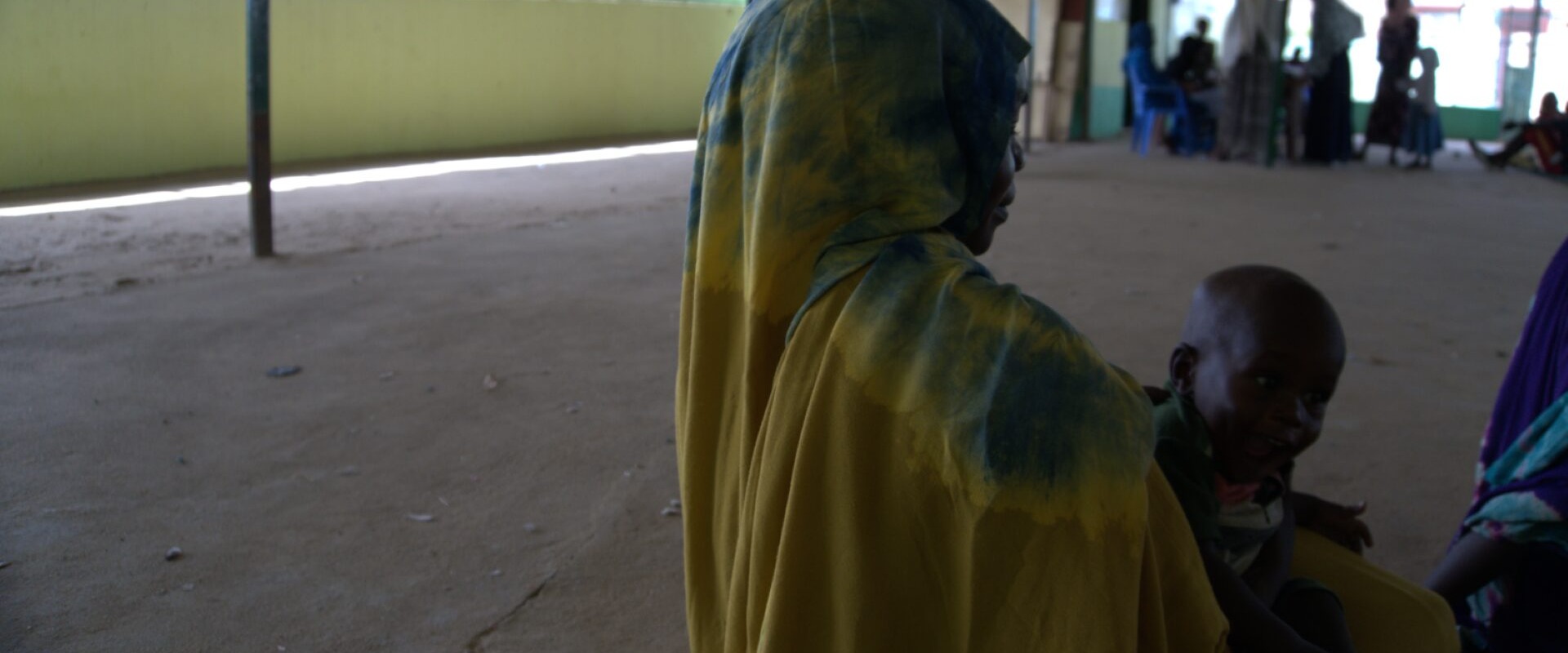 A 27-year-old mother and seasonal farmer receives RUTF and medicine for her child from a health facility.
