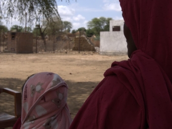 A 30-year-old mother and farmer receives RUTF for her child from a health facility.