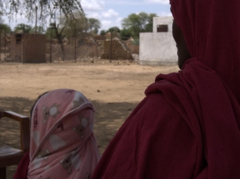A 30-year-old mother and farmer receives RUTF for her child from a health facility.
