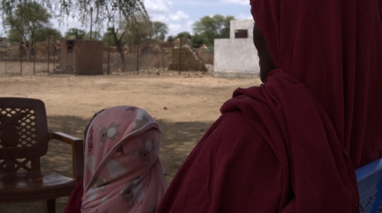 A 30-year-old mother and farmer receives RUTF for her child from a health facility.