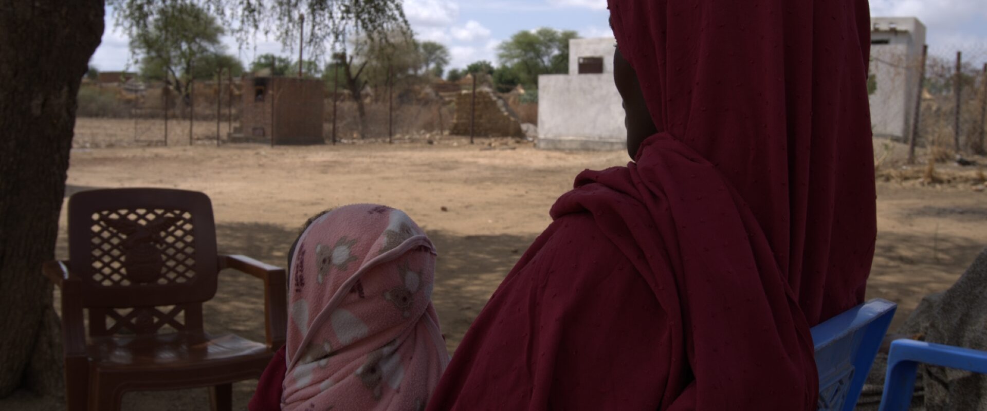 A 30-year-old mother and farmer receives RUTF for her child from a health facility.