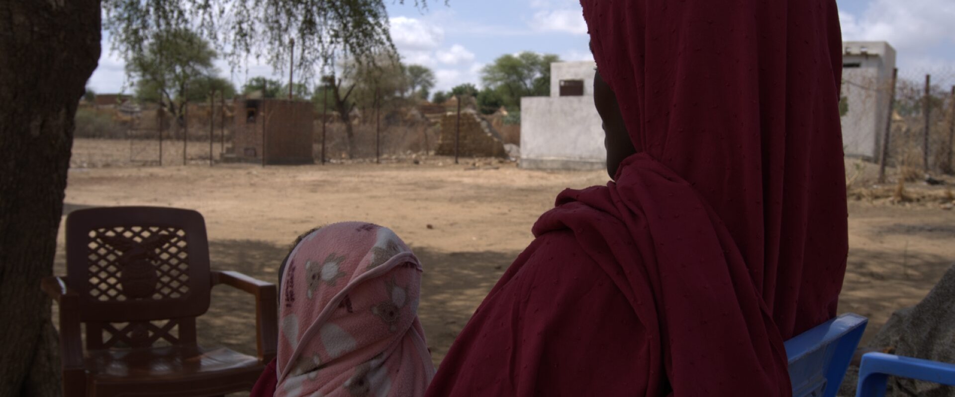 A 30-year-old mother and farmer receives RUTF for her child from a health facility.