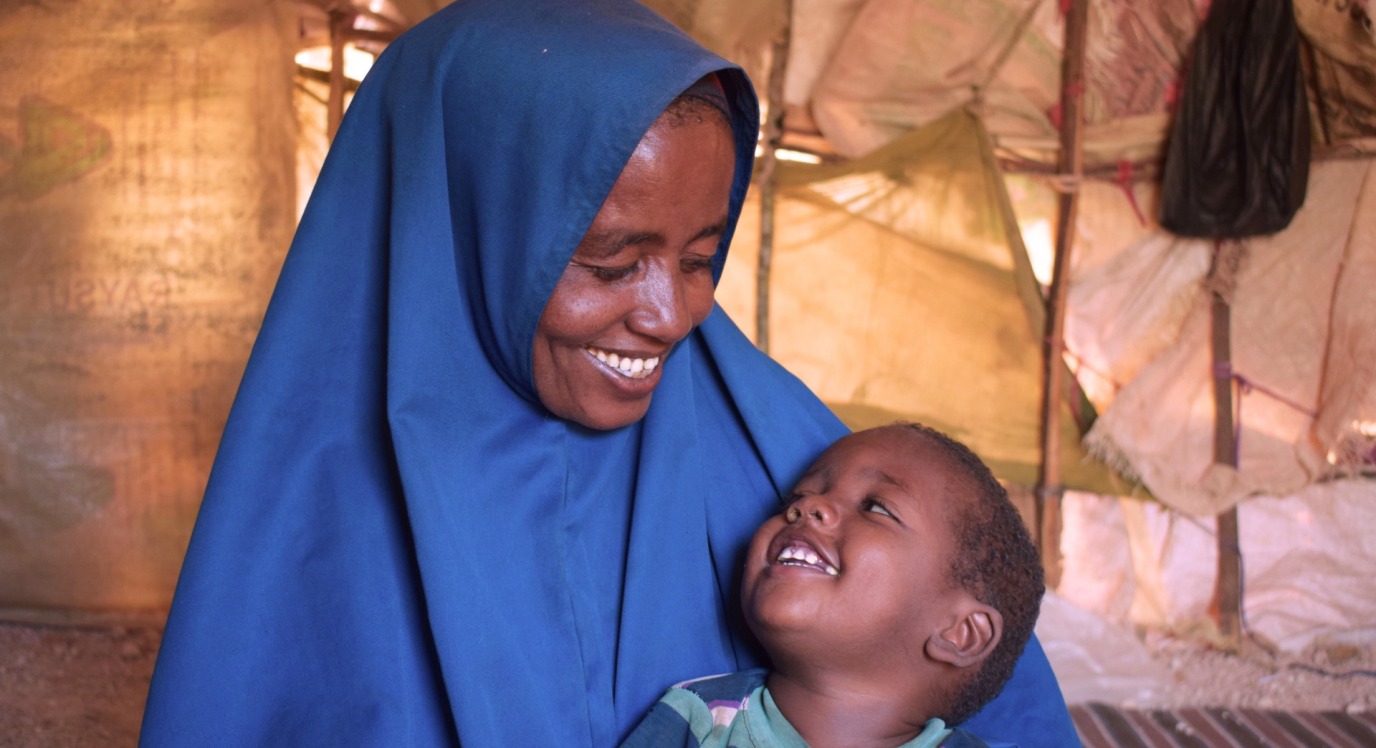 A happy mother and child look at each other