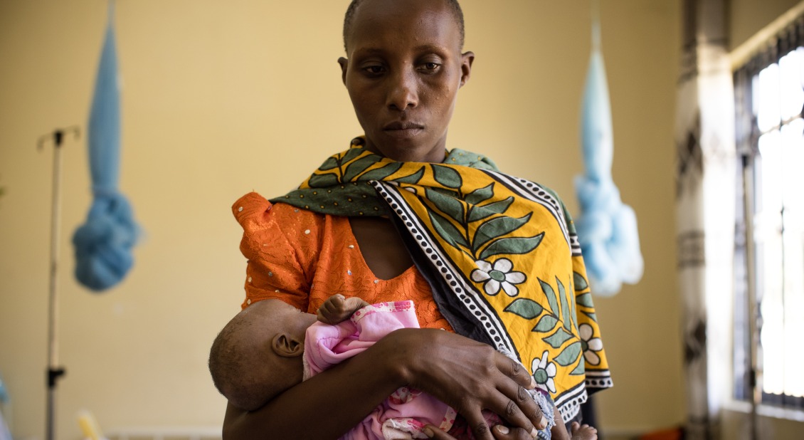 A mother holds her child in a Therapuetic Feeding Unit in Tanzania.