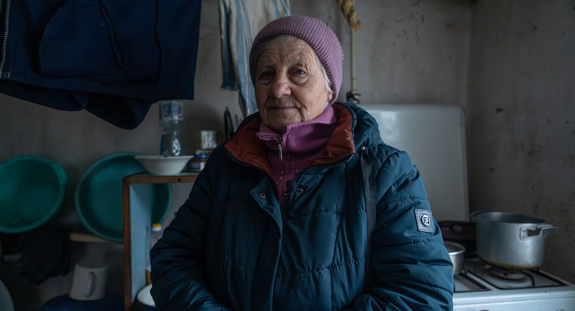 A woman stands in her home in Ukraine