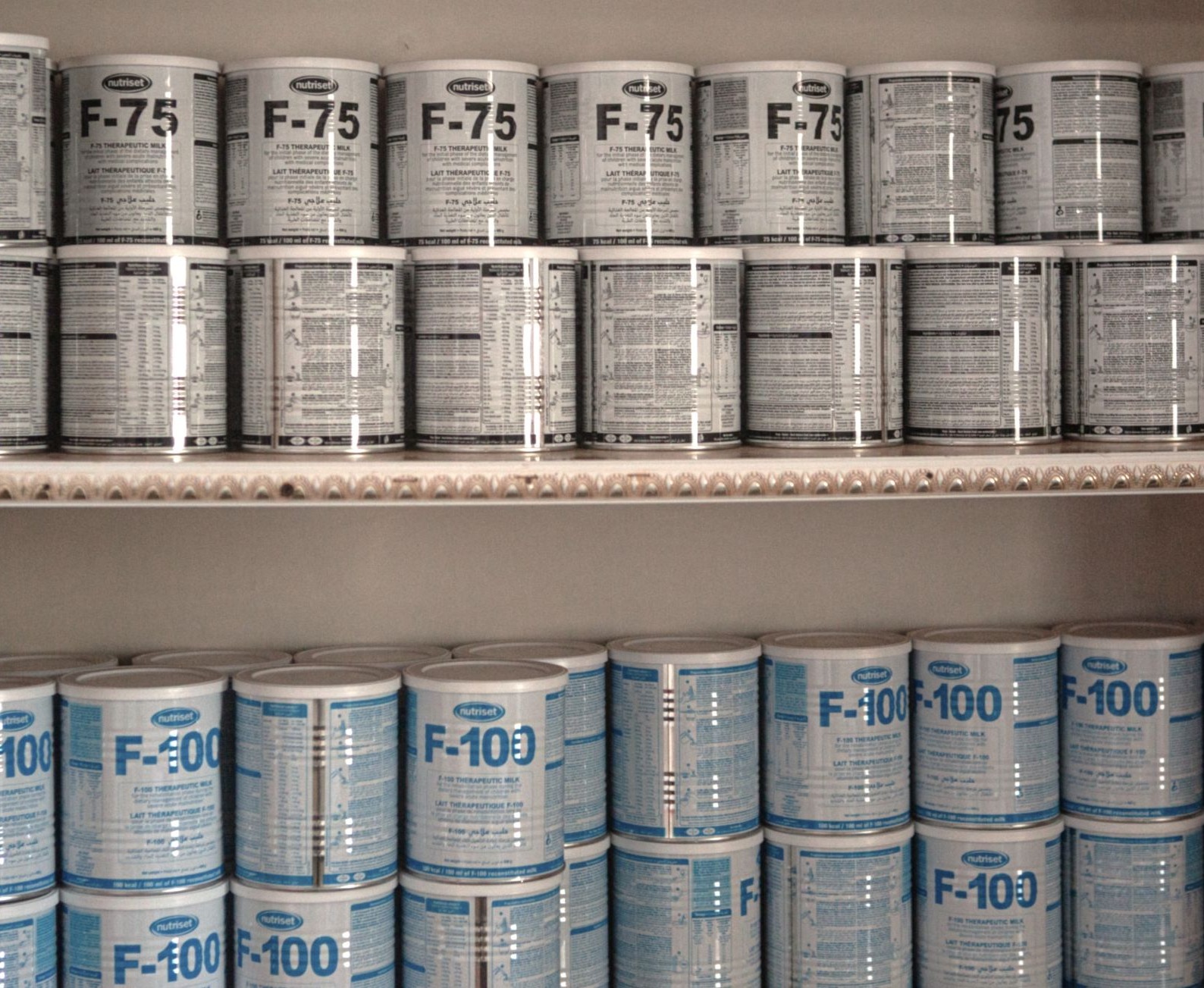 Tins of F-75 and F-100 therapeutic milks.